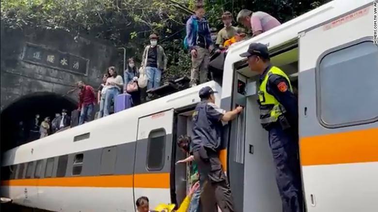 A busy passenger train carrying 490 people has derailed in a tunnel in eastern Taiwan, killing at least 50 and injuring dozens more, authorities said.